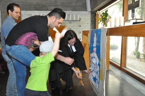 Viele Glieder, ein Leib: die Gottesdienstbesucher hefteten ihre Gaben an das Plakat am Altar
