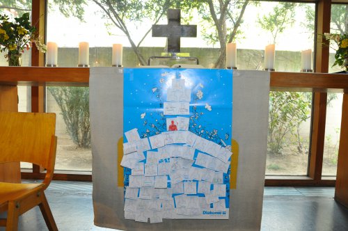 Viele Glieder, ein Leib: die Gottesdienstbesucher hefteten ihre Gaben an das Plakat am Altar