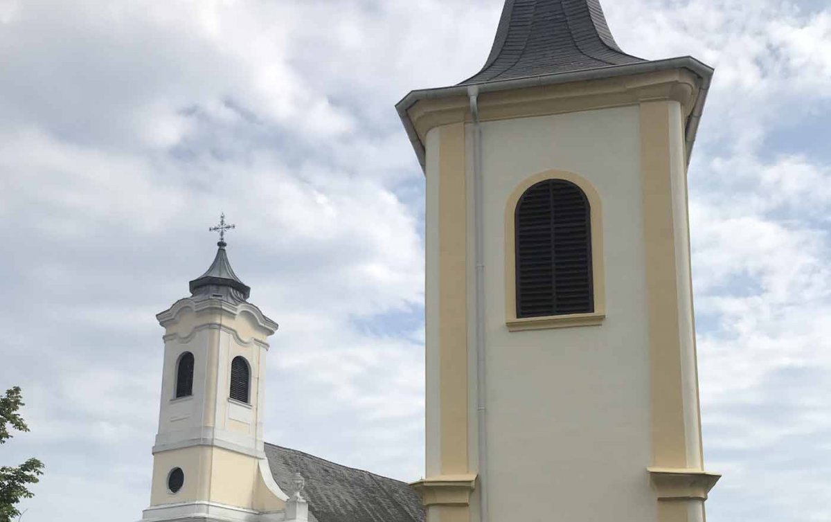 Ein &quot;kleines, selbstbewusstes Zeichen genau gegenüber der katholischen Ortskirche&quot; - der Glockenturm von Walbersdorf, hier im Vordergrund. Foto: privat